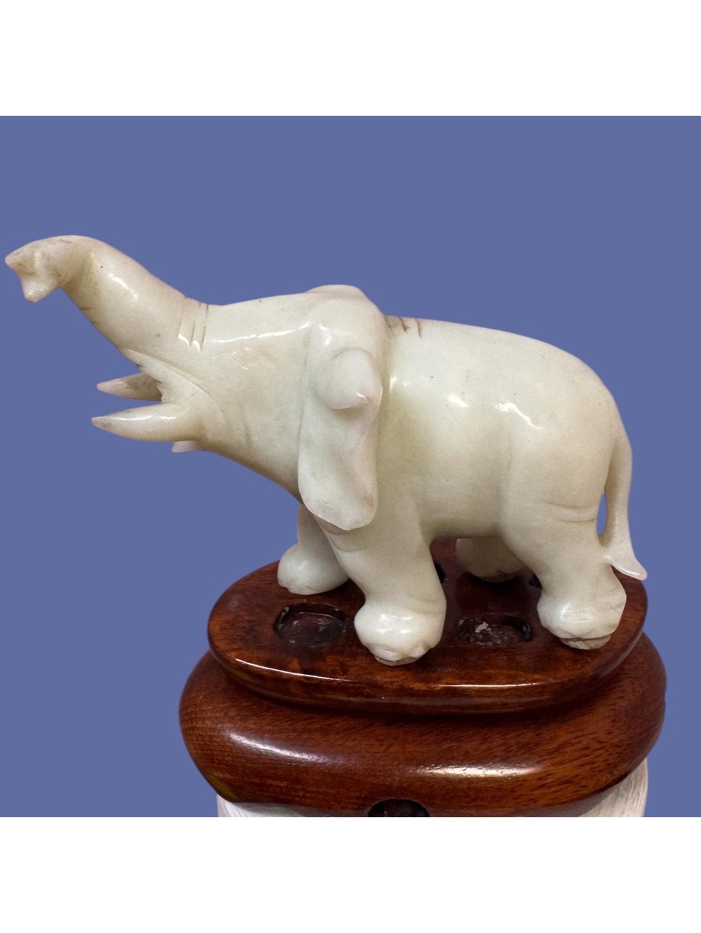Vintage pale  green  jadeite elephant on carved wood base.